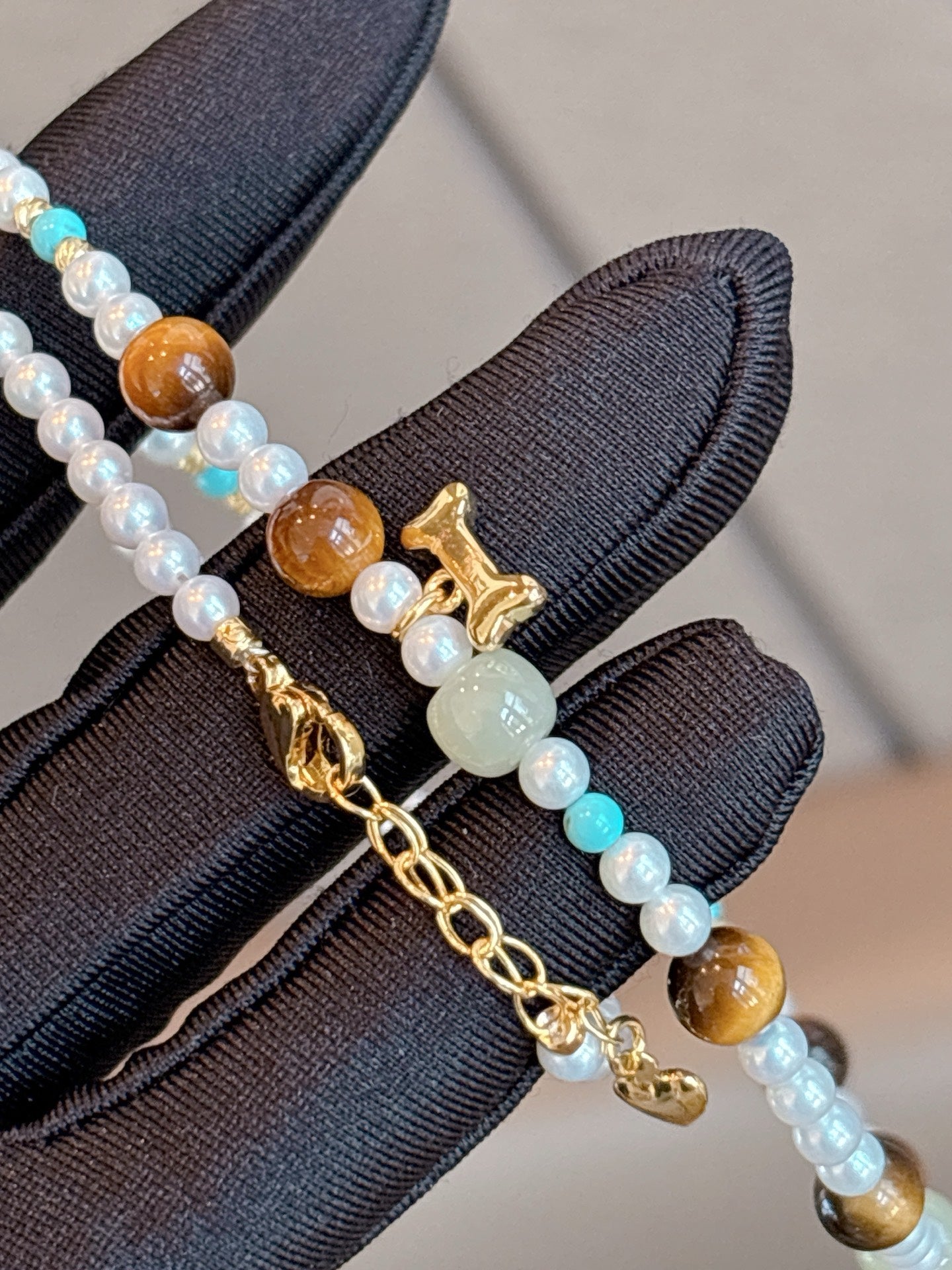Close-up of 3.5–4mm aurora pearls and natural stone detailing