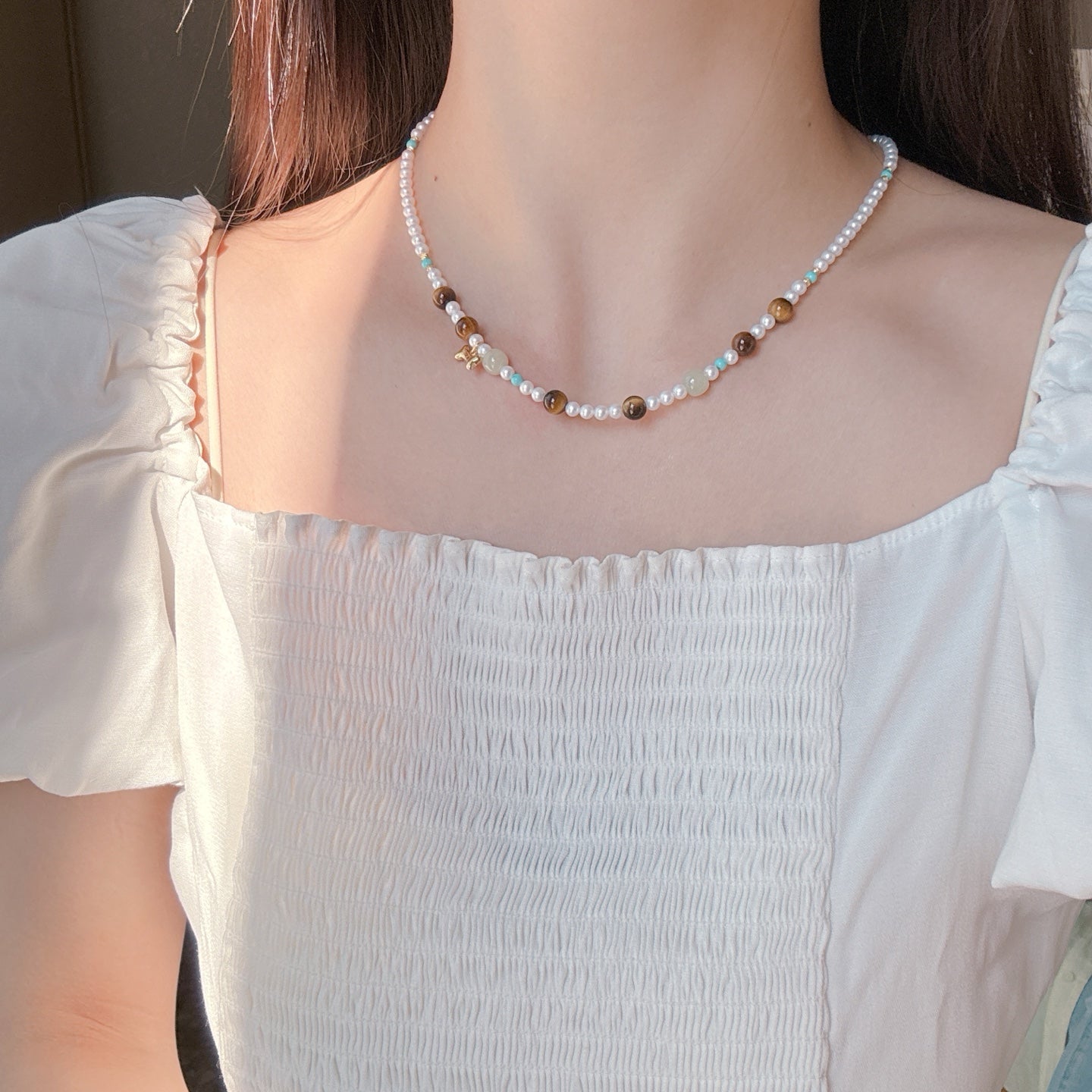 Model wearing artistic multicolor pearl necklace