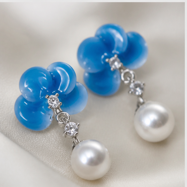 Macro detail of the white freshwater pearls and pale blue blossom connectors
