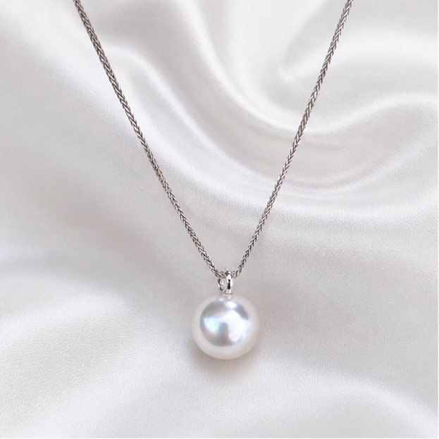 Round white pearl pendant on a fine silver-tone chain with a plain polished bail