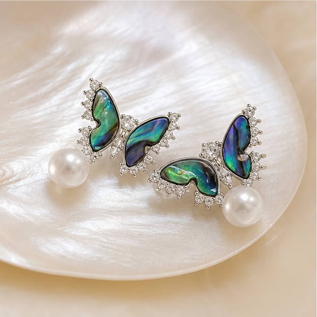 Aurora Wing – Butterfly Pearl Studs in a product-only clear glass still life
