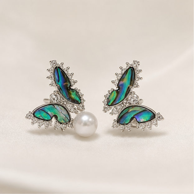 Aurora Wing – Butterfly Pearl Studs photographed on ivory satin
