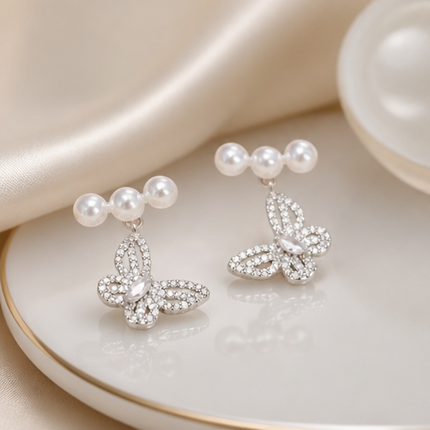 Butterfly Freshwater Pearl Stud Earrings – Delicate Elegance in a product-only clear glass still life