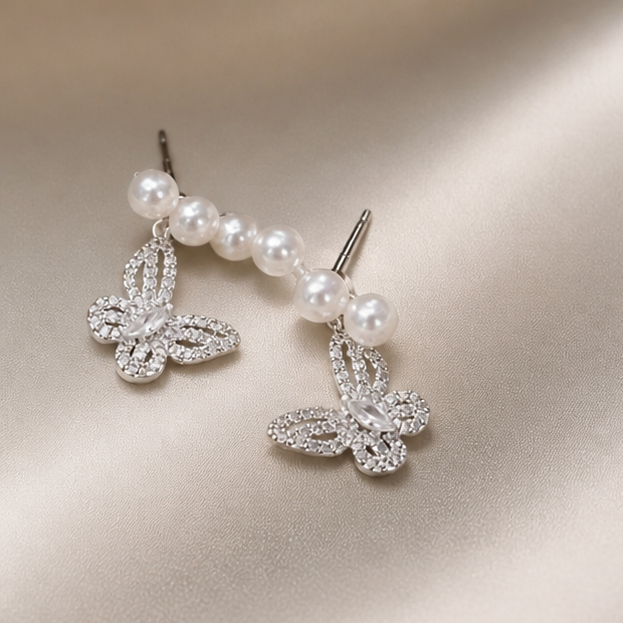Butterfly Freshwater Pearl Stud Earrings – Delicate Elegance photographed on ivory satin
