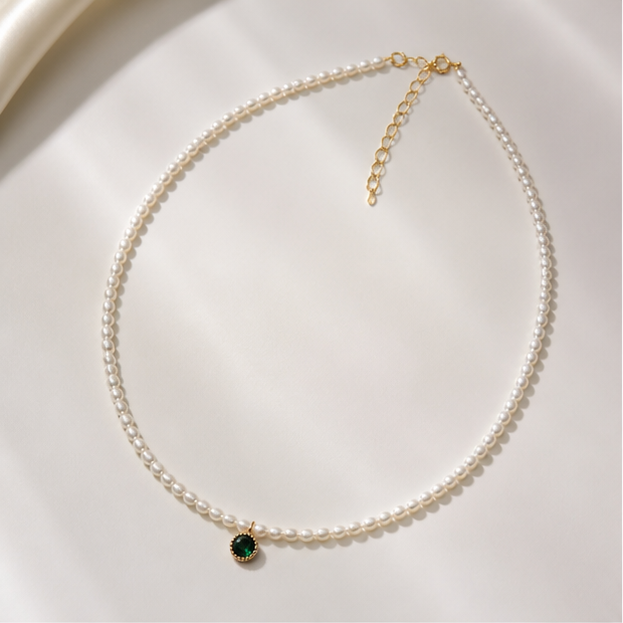 Mini Pearl Necklace with Green Crystal Accent – 3mm Chic Design photographed on ivory satin
