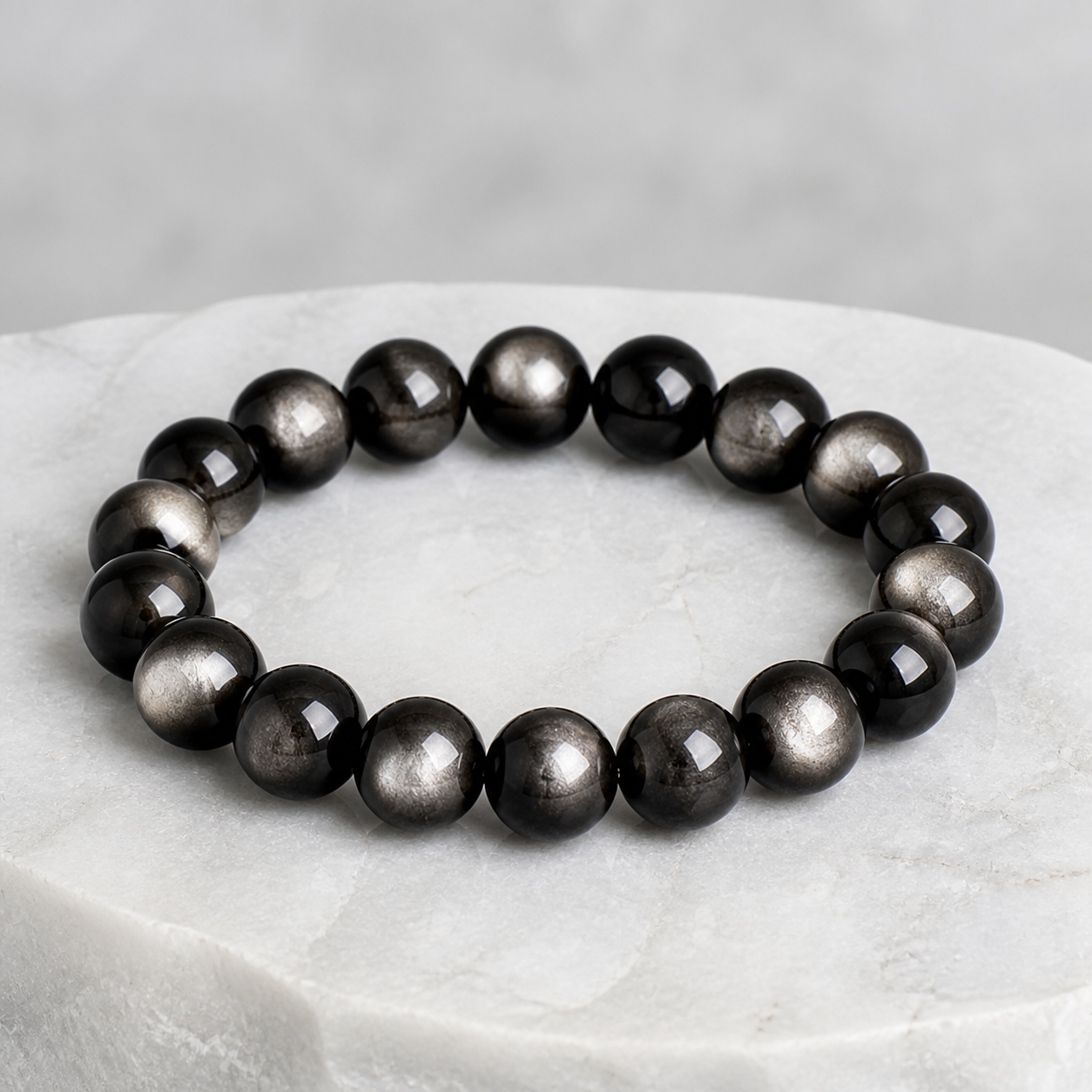Luna Veil Silver Obsidian Bracelet photographed on ivory satin