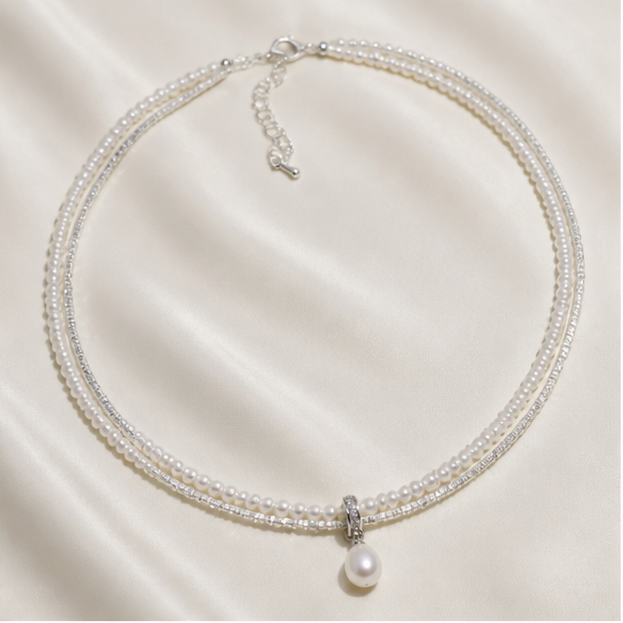 Double-Layer Sterling Silver Pearl Necklace – Drop Pearl & Baby Pearl Shine photographed on ivory satin