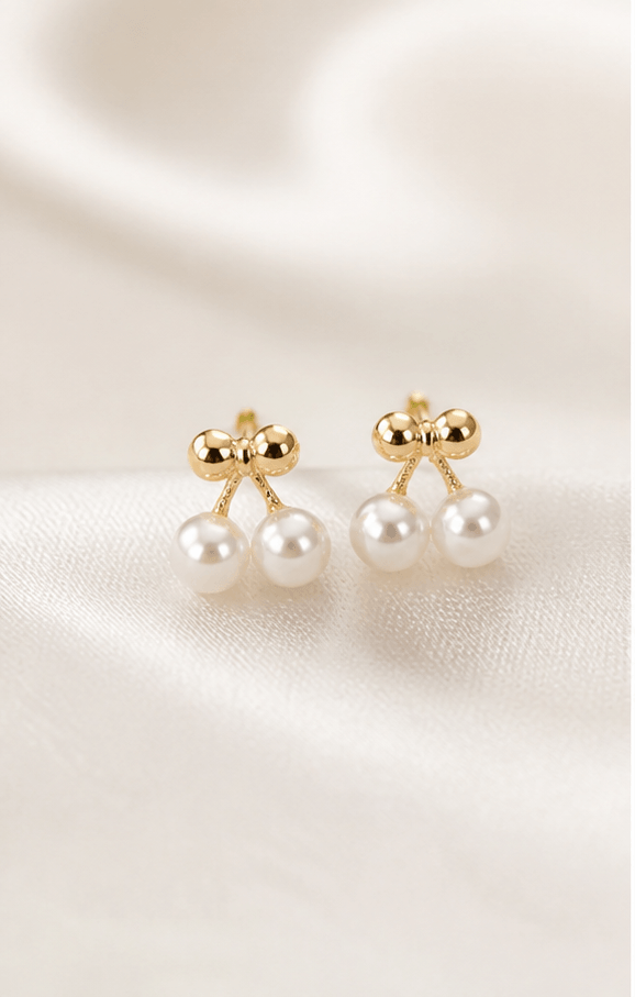Elysian Pearl Mini Cherry Pearl Stud Earrings in a product-only ivory studio setting