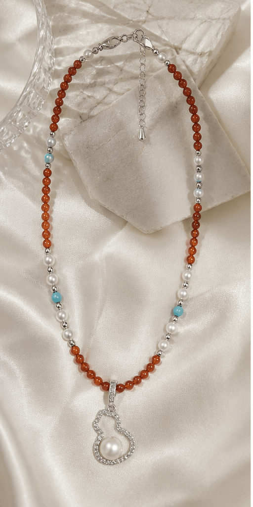 Elysian Pearl Red Agate Pearl Gourd Necklace in a product-only ivory studio setting