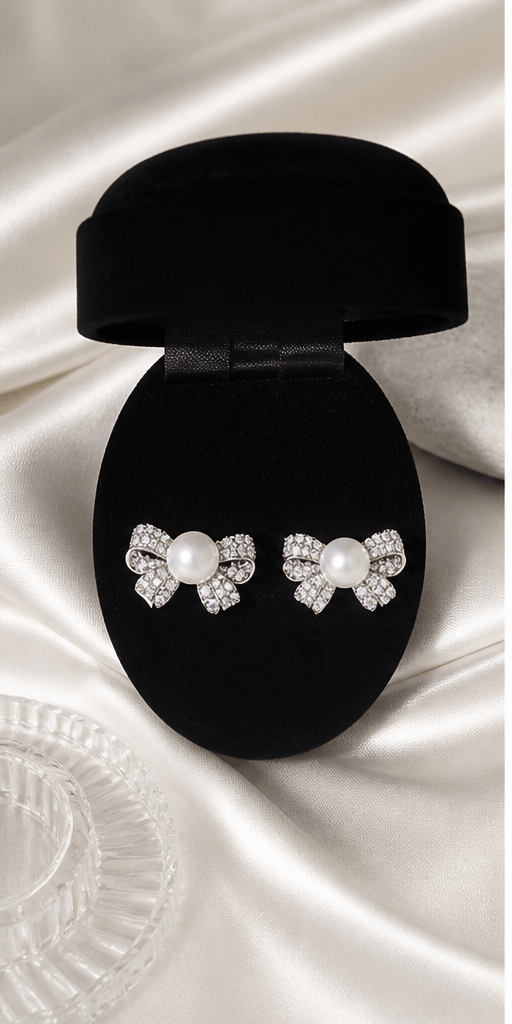 Elysian Pearl Bow Pearl Jewellery Set in a product-only ivory studio setting